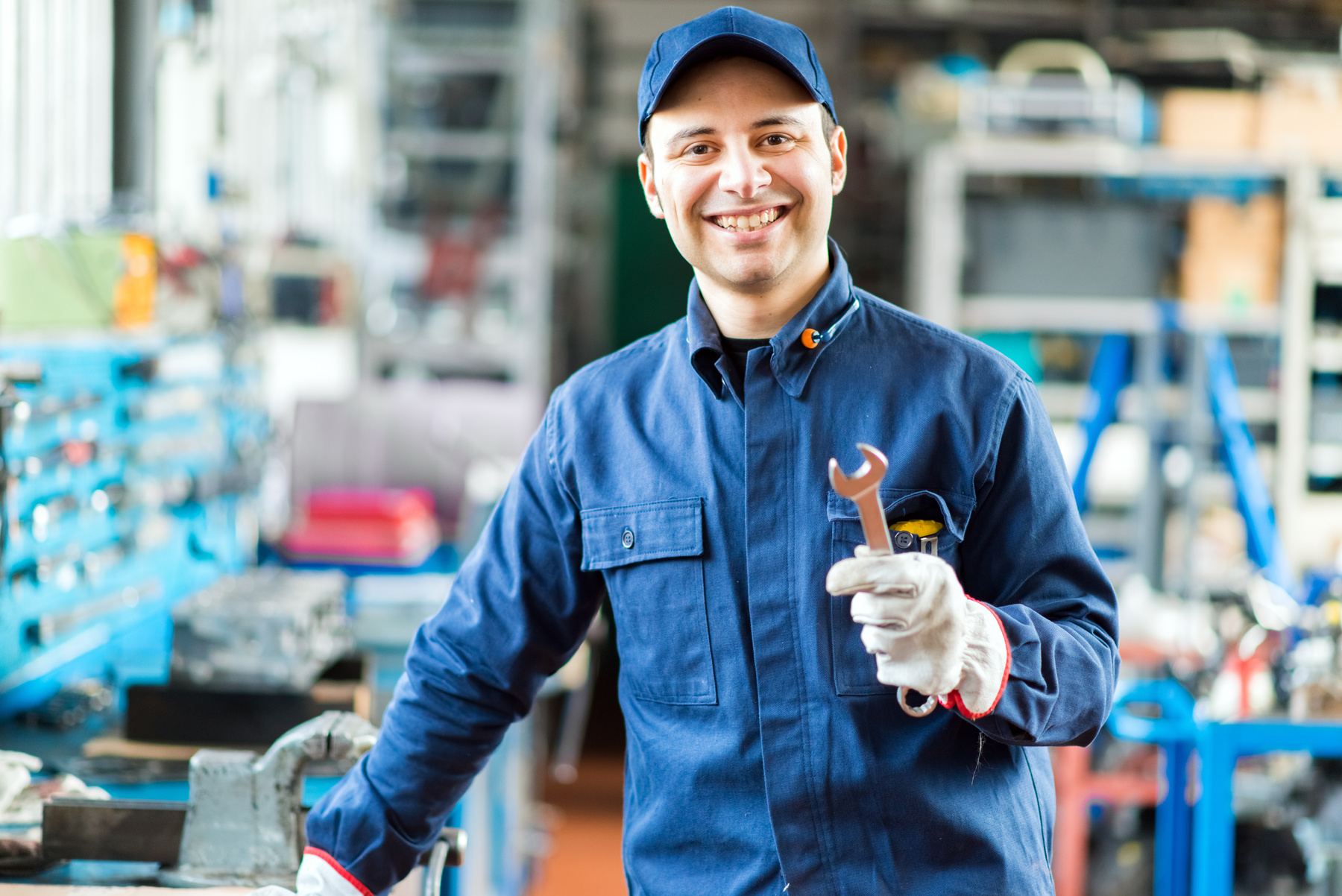 Auto mechanic smiling in his garage