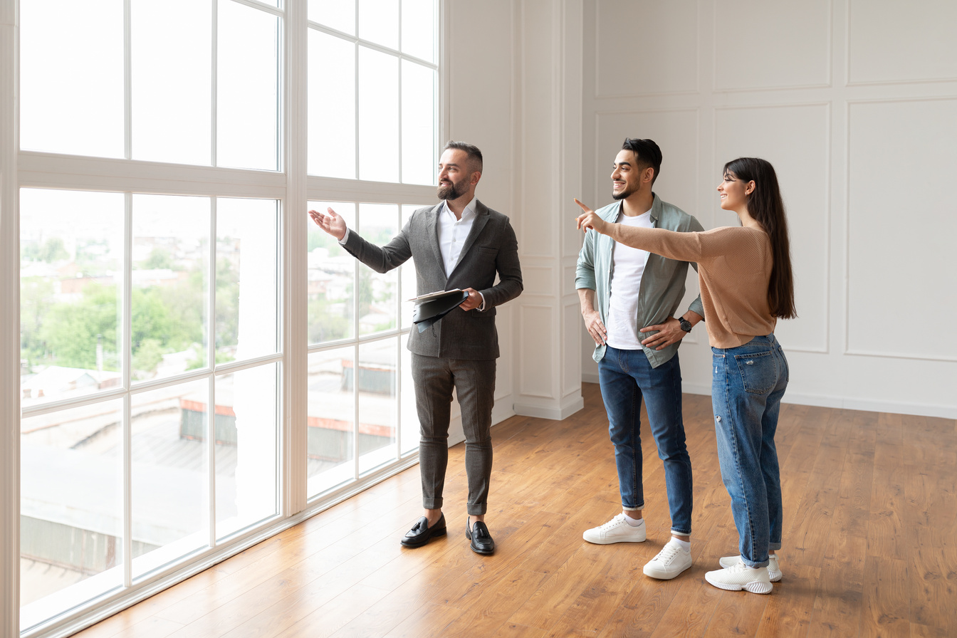 Real Estate Agent Showing Young Buyers New Property