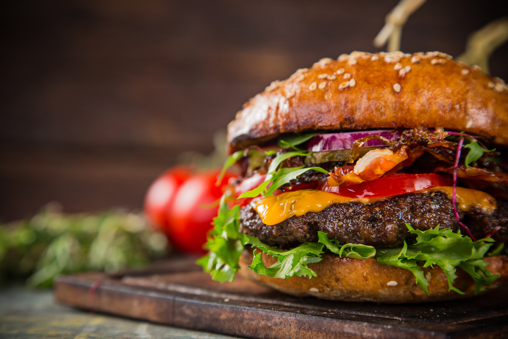 Tasty burgers on wooden table