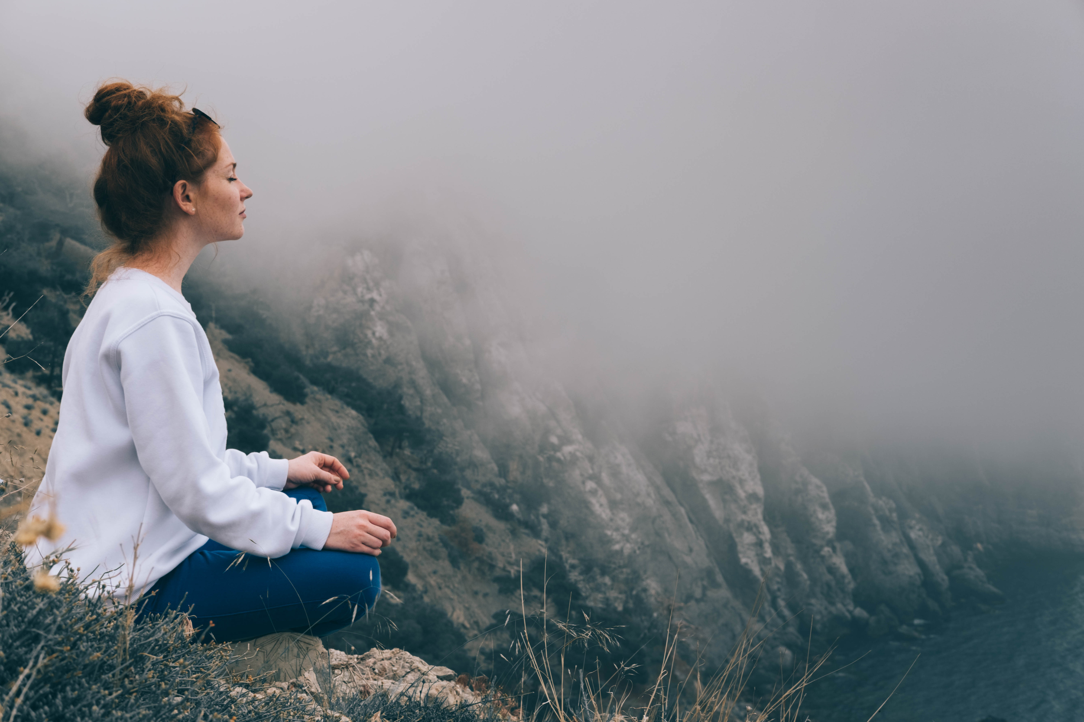 Woman Meditating in the Mountains