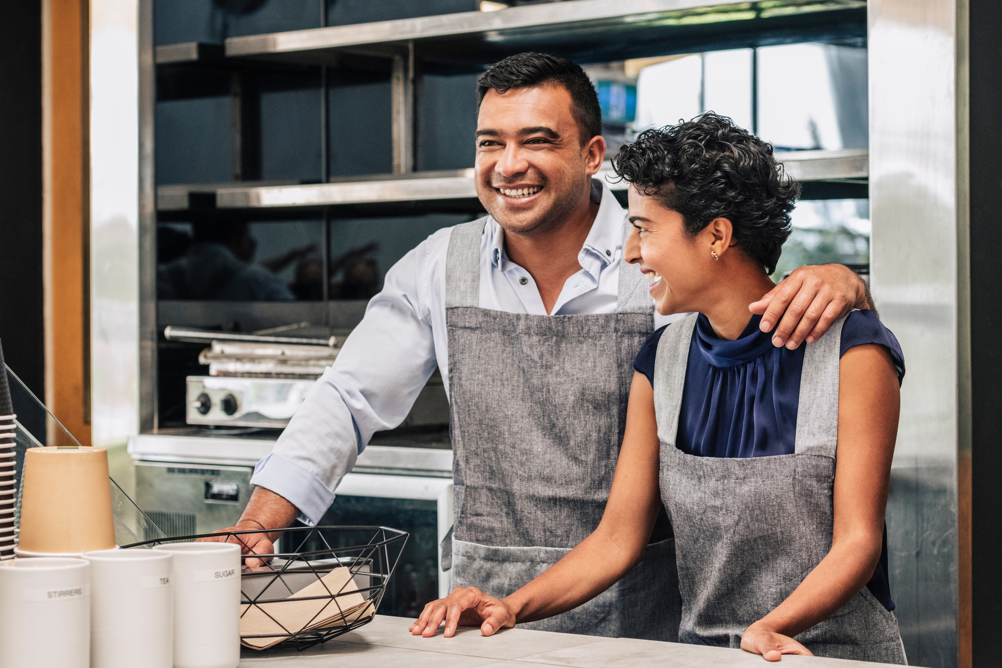 Happy small business owners at their cafe.