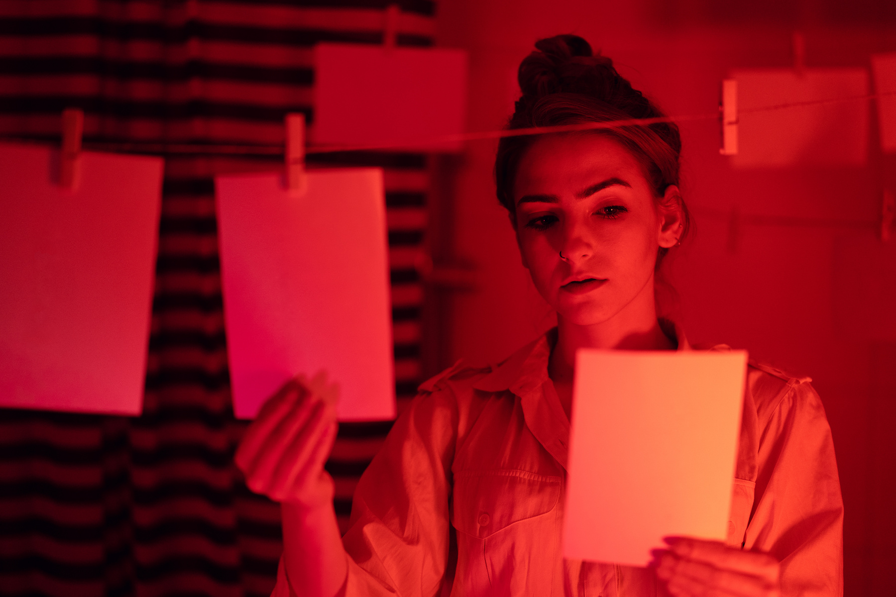 Girl developing photos in darkroom